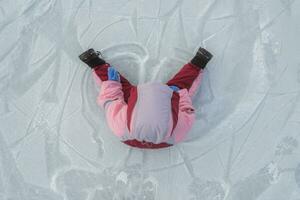 little baby sits on ice in winter photo