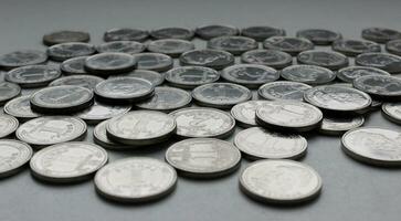 Ukrainian money in nickel coins with ridged edge scattered on a white background closeup photo