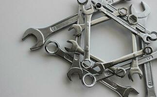 Arranged in the straight geometric shape variety ring wrenches, box end spanners and hex wrenches and on white surface photo