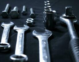 Bolts, Spanners And Socket Wrench Nozzles Isolated On Black Closeup Angle View photo