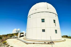 the large white telescope sits on top of a hill photo