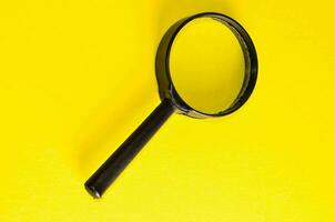 magnifying glass on a yellow background photo