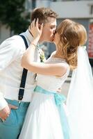 the bride and groom kissing near the registry office photo