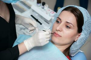 Preparing the oral cavity for whitening with an ultraviolet lamp. Close-up photo