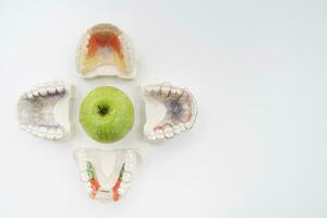 ceramic jaws with a clasp lie with an apple on the table photo