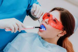 doctor orthodontist examines the patient after brushing his teeth photo