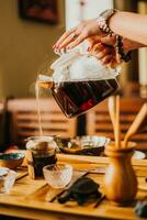 girl pours fresh green tea in coffee photo