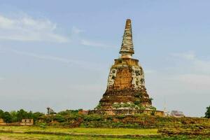 the ancient buddhist pagoda in the middle of the field photo