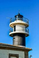 a lighthouse with a black and white tower photo