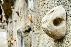 a rock climbing wall with a large rock on it photo