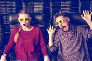 guy and girl 3d glasses are very worried while watching a movie in a cinema photo