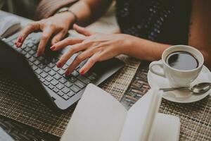 business woman in coffee prints on a laptop close-up photo