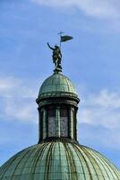 a statue of a man on top of a dome photo