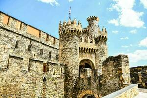 the castle is made of stone and has a tower photo