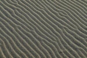 a close up of sand with ripples in it photo