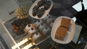 Variety of cakes on display at a buffet in a restaurant. photo