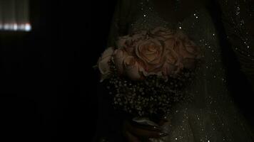 Wedding bouquet of roses in the hands of the bride photo