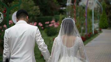 The bride and groom are walking in the park on their wedding day. photo