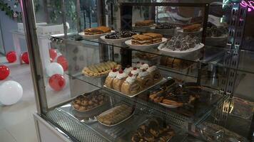 Showcase with different types of cakes and cookies in the shop window photo