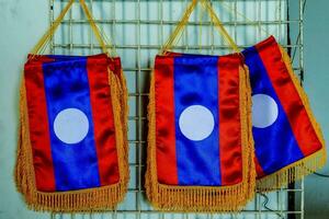 three flags hanging on a metal rack photo