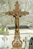 a statue of jesus on a cross in a cemetery photo