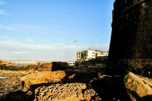 a view of the sea and a building on the shore photo