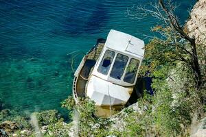 a boat is sitting on the edge of a cliff photo