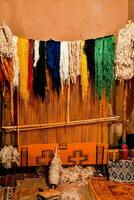 a room with many colorful yarns on a wall photo