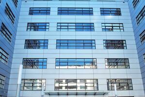 Modern office building in the city with windows and  steel and aluminum panels wall. photo