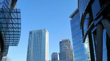 Structural glass wall reflecting blue sky. Abstract modern architecture fragment photo