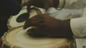 A set of drums being played at an Indian wedding video