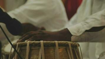 A set of drums being played at an Indian wedding video