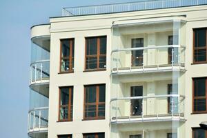 Modern luxury residential flat. Modern apartment building on a sunny day. White apartment building with a blue sky. Facade of a modern apartment building. photo