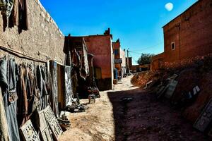 a narrow alley with lots of clothes hanging on the wall photo