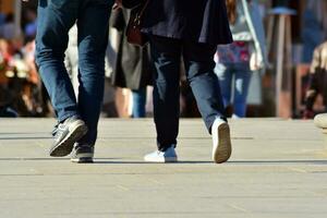 People walking on big city street, blurred motion crossing abstract photo