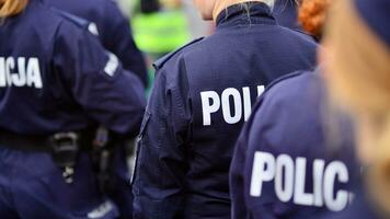 Police sign - logo on the back of the police uniform. Policja. photo