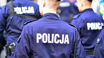 Police sign - logo on the back of the police uniform. Policja. photo