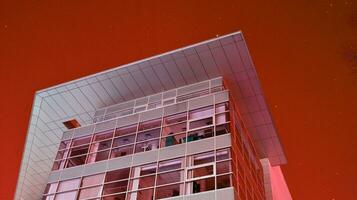 Night architecture - building with glass facade. Modern building in  business district. Concept of economics, financial. Photo of commercial office building exterior. Abstract image of office building