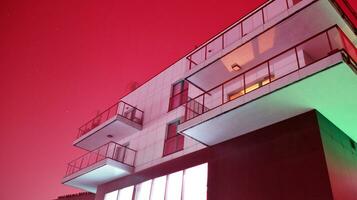 Night architecture - building with glass facade. Modern building in  business district. Concept of economics, financial. Photo of commercial office building exterior. Abstract image of office building