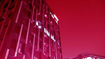 Night architecture - building with glass facade. Modern building in  business district. Concept of economics, financial. Photo of commercial office building exterior. Abstract image of office building