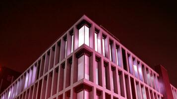 Night architecture - building with glass facade. Modern building in  business district. Concept of economics, financial. Photo of commercial office building exterior. Abstract image of office building