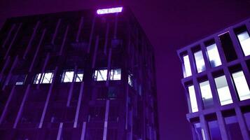 Night architecture - building with glass facade. Modern building in  business district. Concept of economics, financial. Photo of commercial office building exterior. Abstract image of office building