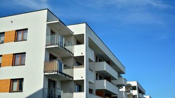 Modern apartment buildings on a sunny day with a blue sky. Facade of a modern apartment building. Glass surface with sunlight. photo