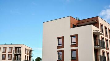 Modern apartment buildings on a sunny day with a blue sky. Facade of a modern apartment building. Glass surface with sunlight. photo