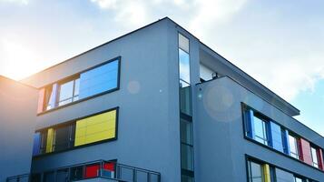 A view at a straight facade of a modern building with a dark grey facade. Dark grey metallic panel facad. Modern architectural details. photo