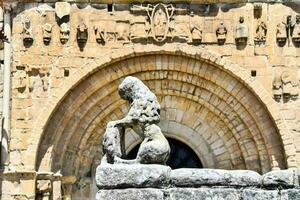 a stone statue in front of a building with arches photo