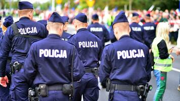 Police sign - logo on the back of the police uniform. Policja. photo