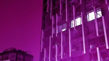 Night architecture - building with glass facade. Modern building in  business district. Concept of economics, financial. Photo of commercial office building exterior. Abstract image of office building