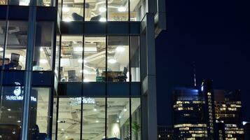 Pattern of office buildings windows illuminated at night. Glass architecture ,corporate building at night - business concept. photo
