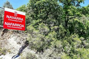 a sign that says navarra on a hillside photo